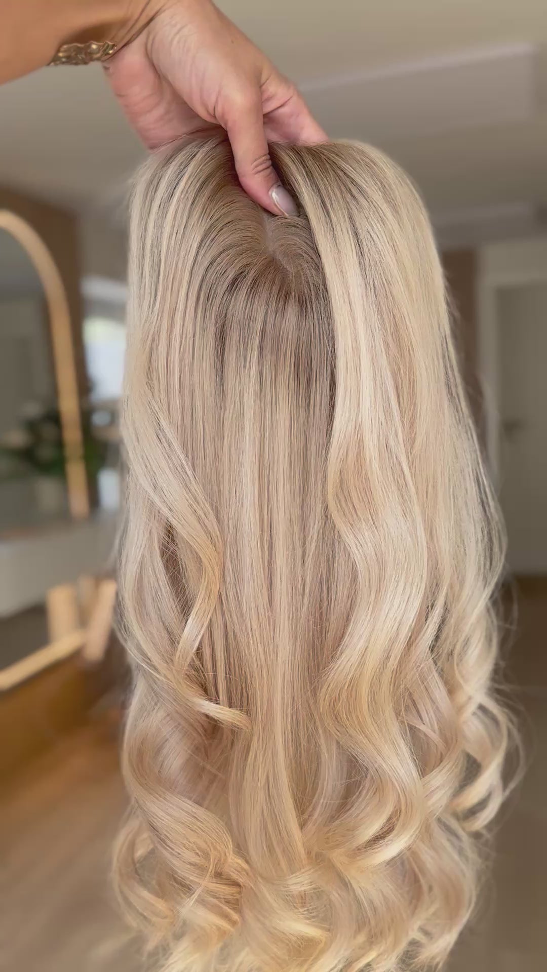 blondes Echthaarteil wird frontal im Video gezeigt. Video dient der Produktpräsentation eines Artikels in der Kategorie Topper/Perücken.